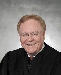 Headshot of man in judge's robes